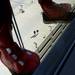 Two men watch from the top of a parking garage as a superhero hangs from a rope. Melanie Maxwell I AnnArbor.com